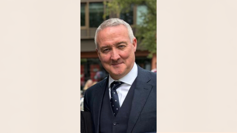 Suited academic with a smile